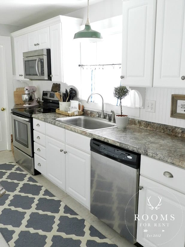 Love this white kitchen with fun farmhouse details kellyelko.com