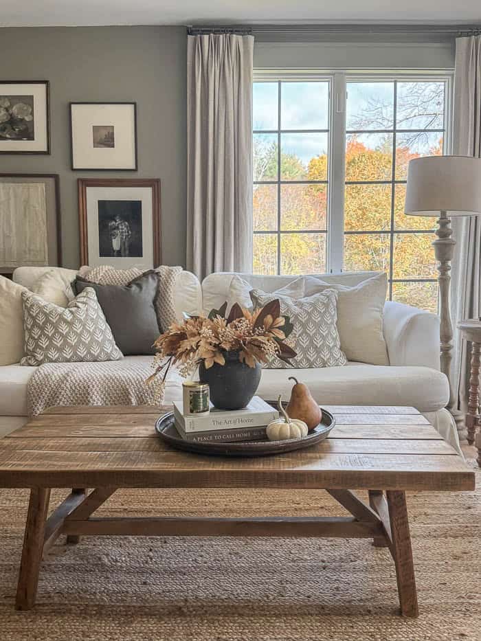 Wood coffee table with fall centerpiece and home decor books
