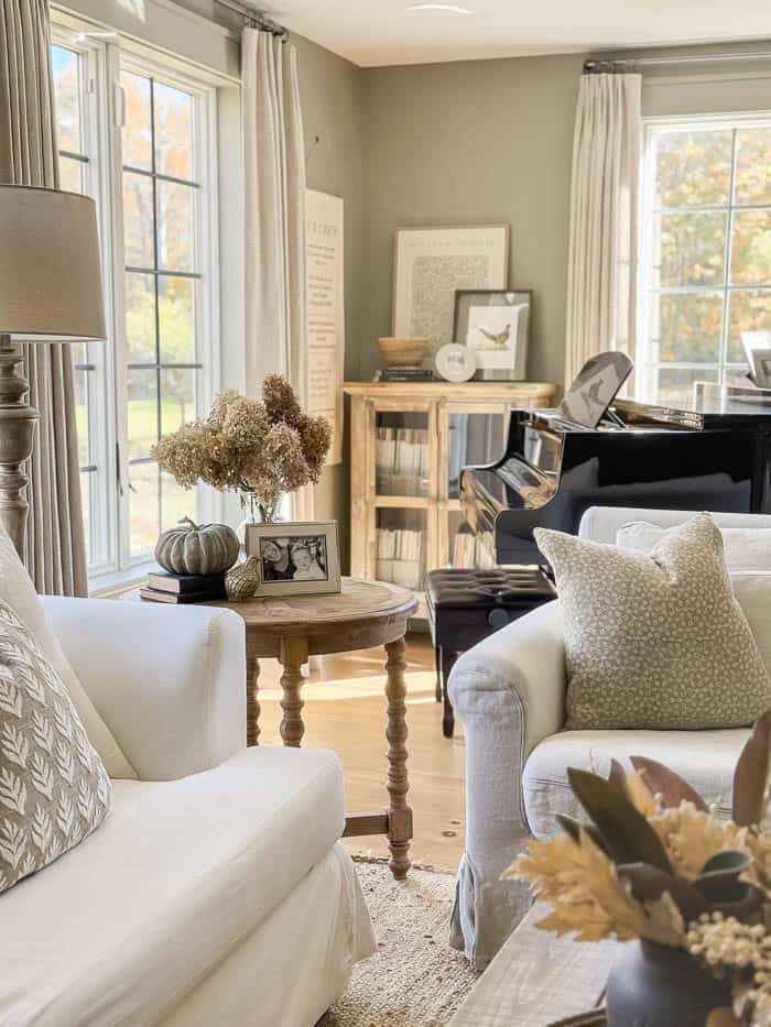 Cozy fall living room with neutral decor and white slipcovered sofas