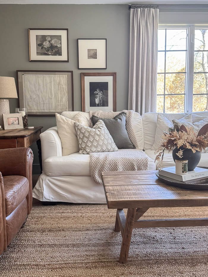 Cozy fall living room with neutral decor and white slipcovered sofas