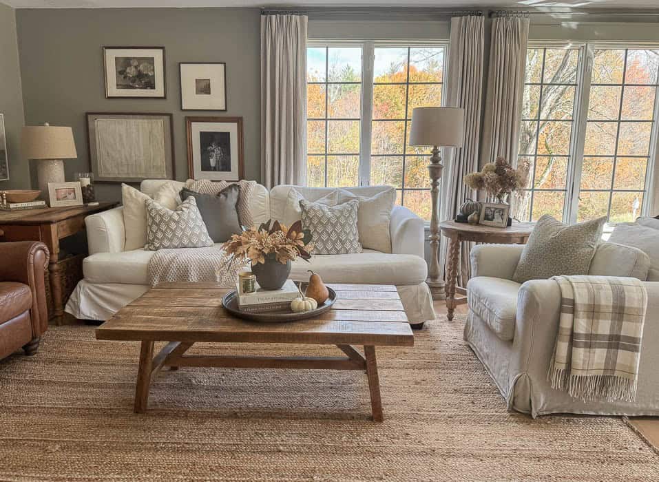 Cozy fall living room with neutral decor and white slipcovered sofas