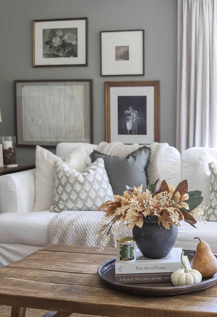 Wood coffee table with fall centerpiece and home decor books