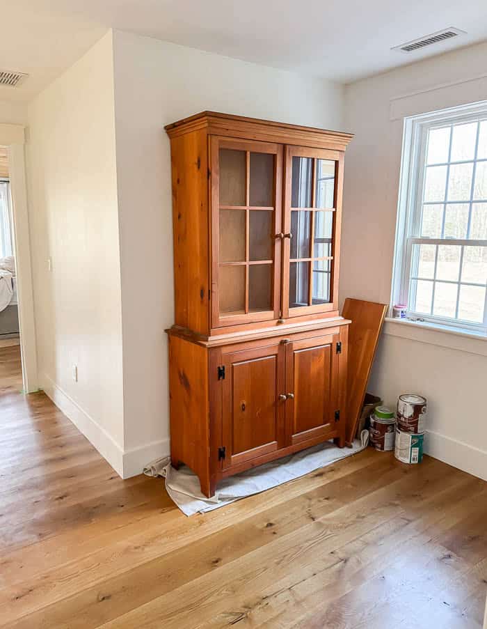 Wood hutch before makeover, original finish from Facebook Marketplace placed in an upstairs hallway prior to painting.