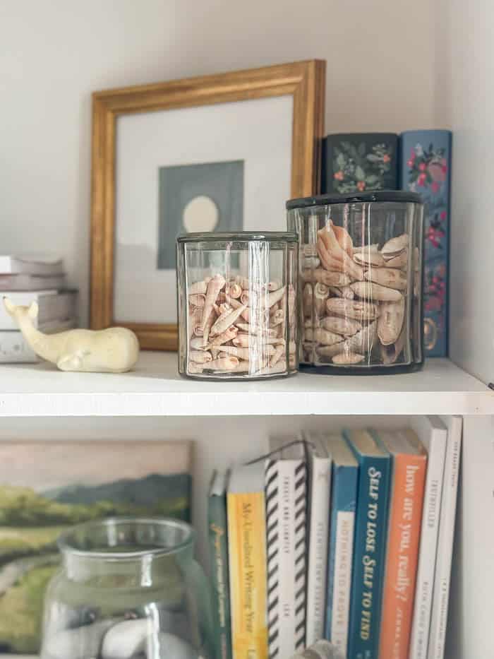 Painted hutch styled with books and seashells, traditional New England Home