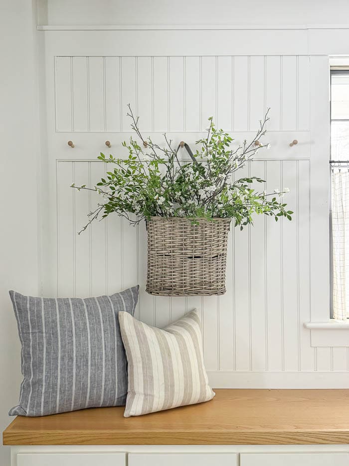 mudroom bench, hanging basket with faux greenery