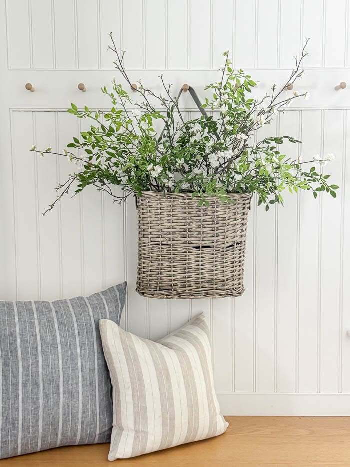 mudroom bench, hanging basket with faux greenery