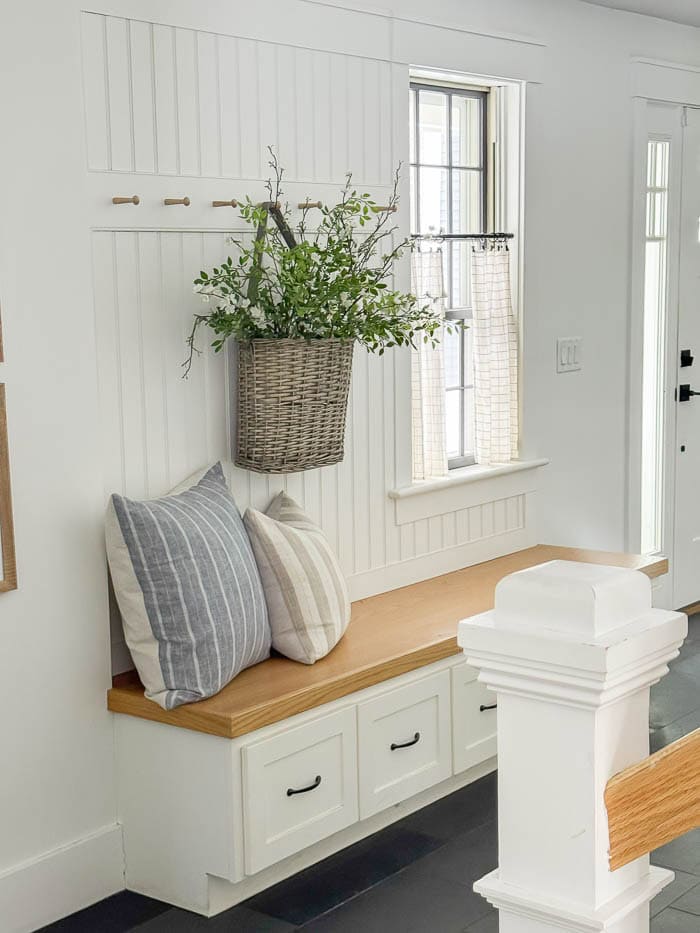 mudroom bench, hanging basket with faux greenery