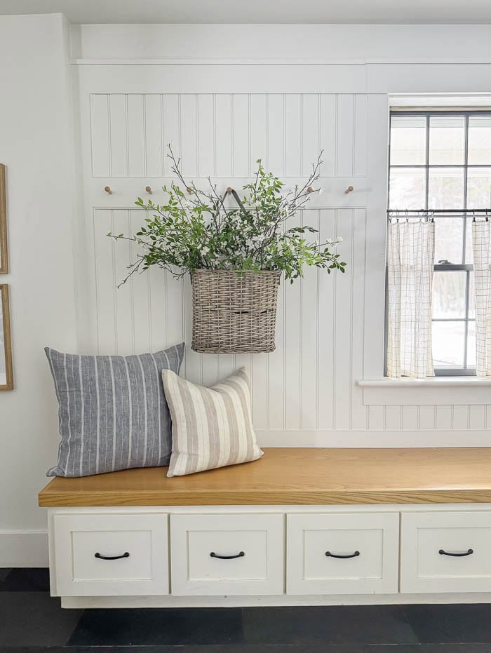 mudroom bench, hanging basket with faux greenery
