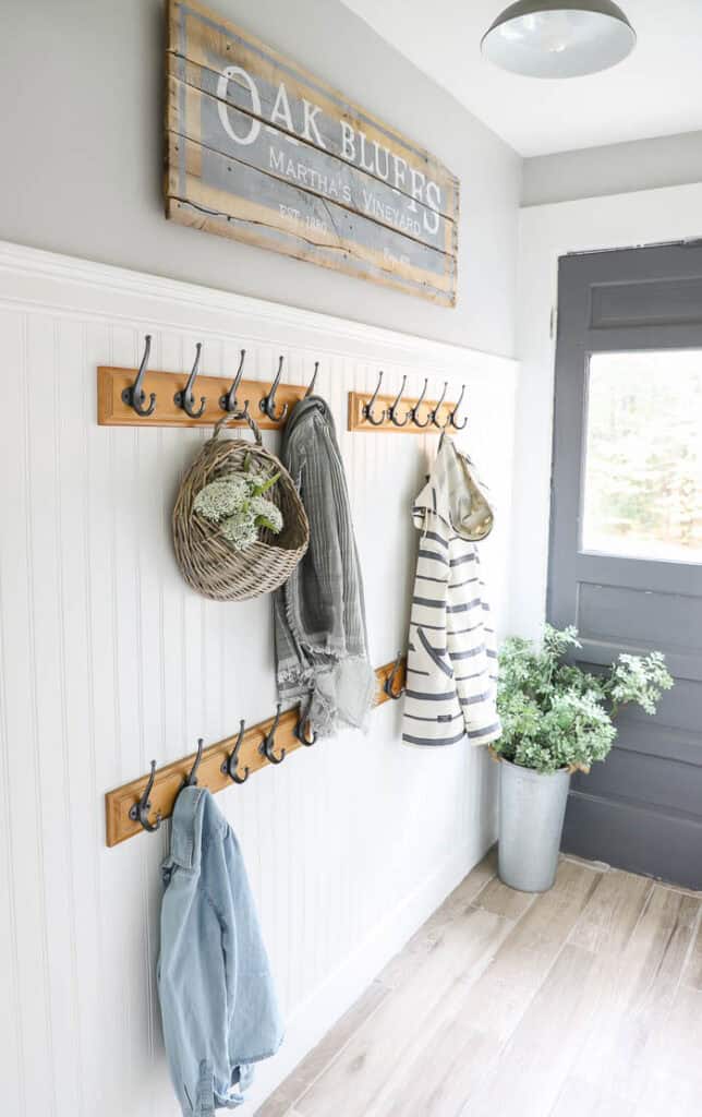 mudroom hallway with beadbaord and hooks for jackets