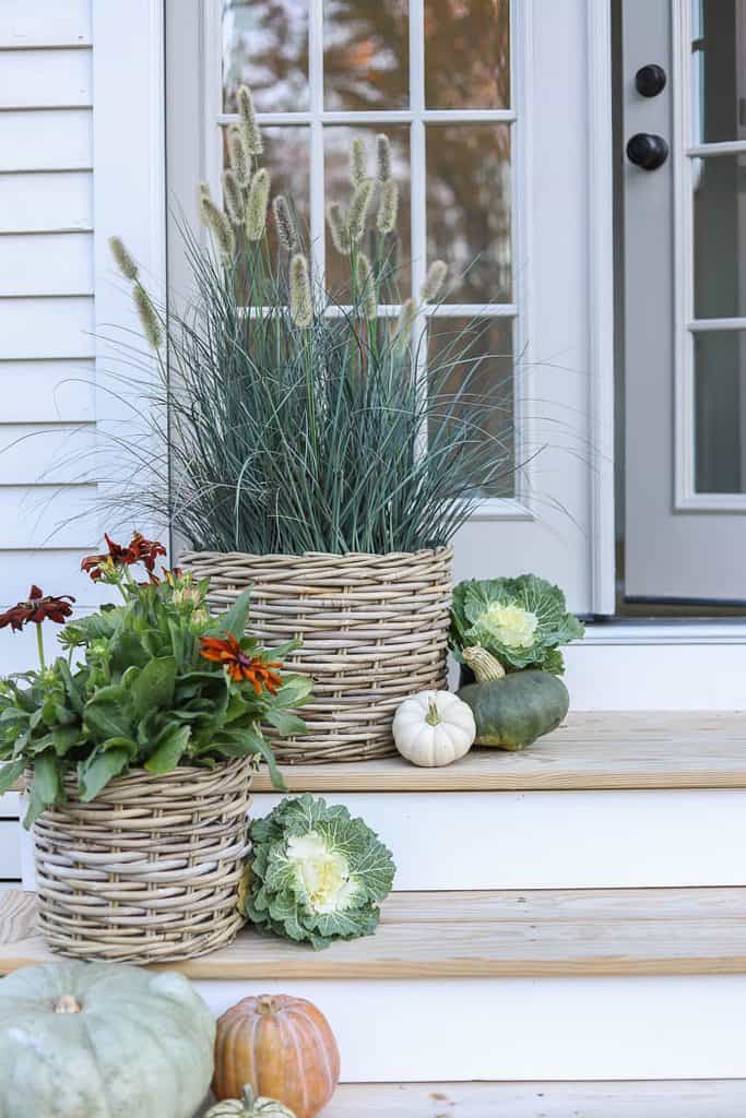 Woven garden baskets filled with ornamental grasses and seasonal flowers