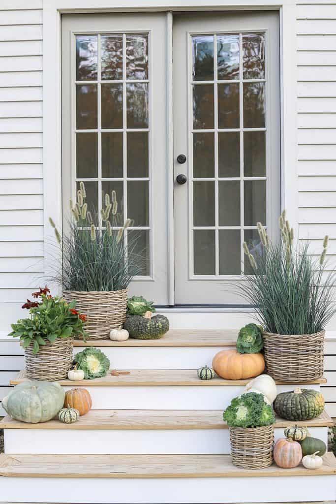 Garden shed steps decorated with woven baskets, ornamental grasses, and pumpkins